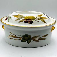 Covered casserole front view showing fruit and wheat pattern, gold trim