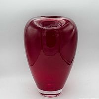 Front view of ruby red art glass vase