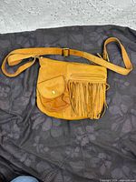 front view of tan leather fringe crossbody purse