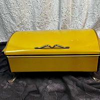 yellow enamel chafing dish closed on stand