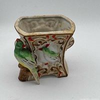 Front view showing rectangular planter opening and applied bird