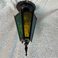 Full view of lantern showing metal frame and multicolor glass