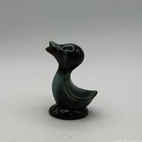 Front-left view of glossy green drip glaze ceramic duck