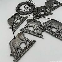 Full view of pewter cow pendants and cords
