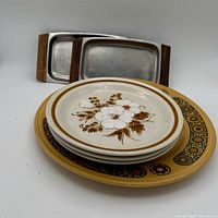 Overview of Kiln Craft plate, floral plates stack, stainless trays