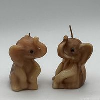 Front view of both marbled wax elephant candles