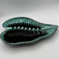 Top view showing leaf shape, ribbed interior, green and black drip glaze