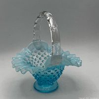 Angled view showing basket profile, hobnail body, ruffled rim, clear handle