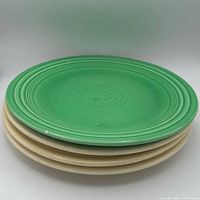 Stack view showing one green and three ivory Fiesta plates