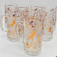 All eight matching clear glass mugs lined in two rows