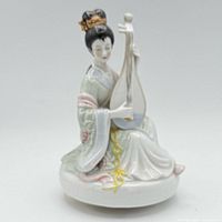 Front view seated porcelain geisha with instrument on music box base