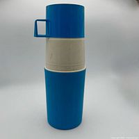Full view of assembled blue and white Thermos bottle