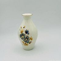 Front view of vase showing blue floral and gold detailing