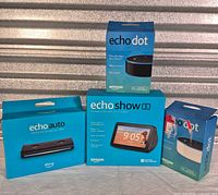 Front view of Echo Auto, Echo Dot, Echo Show 5 boxes plus inner Echo Dot box