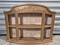 Front view of antique gold curio shelf showing six compartments and damask backing