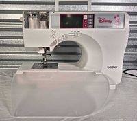 Front view of Brother SE-270D machine with accessory tray attached