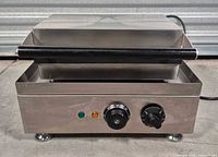 Front view of stainless steel corn dog maker showing controls and indicator lights