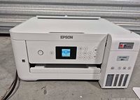 Front view of Epson ET-2850 printer showing control panel and ink tanks