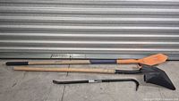 Three tools laid out: orange-blade shovel, black-blade shovel, Kobalt crowbar