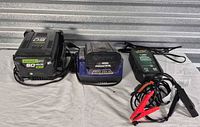 Greenworks battery, Kobalt charger and Battery Tender maintainer displayed together