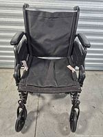 Front view showing seat, armrests, footrests