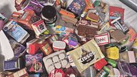 Pile of assorted miniature food replicas showing various branded boxes, jars, bottles and packets