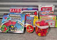 Full group shot showing all eight boxed games plus parts tub