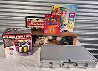 Group shot of all board games, chess pieces and closed aluminium poker case