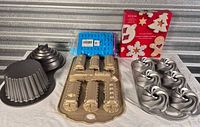 Group shot of all bakeware, cookie cutter box and silicone molds