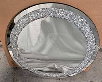 Full view of round mirror showing mirrored frame and crystal band