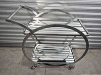 Side profile showing full circular frame, both glass shelves, casters