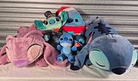 Group shot showing all six Stitch and Angel plush toys