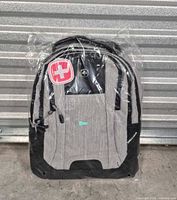 Front view of sealed SwissGear gray/black backpack
