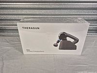 Front of sealed Theragun Elite Wireless Charging Stand box