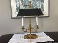 Full view of brass piano lamp with black shade