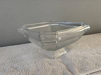Side view of clear octagonal glass bowl on pedestal