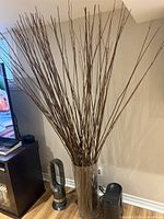 floor vase filled with tall natural twig branches