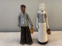 Front view of both ceramic figurines standing side by side