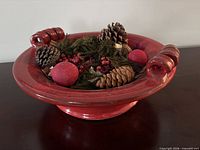 Overall view of red ceramic bowl containing potpourri