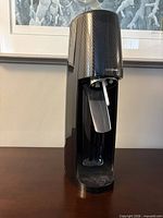 Front view of black SodaStream soda maker