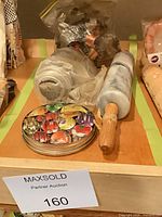 Marble and wooden rolling pins, storage tin and bagged cookie cutters on shelf