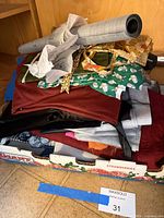 Box of assorted fabric remnants, straps and grey vinyl roll