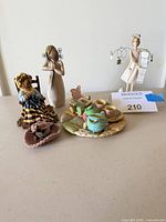 Group shot of all figurines and tea set