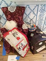Group view: chair, trunk, quilt, pillow, yarn basket