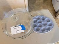 Cake stand lid removed beside blue-gray deviled egg platter