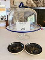 Glass pedestal cake stand with dome and two ceramic dishes