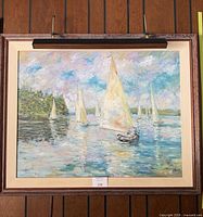 Full view of framed impressionist sailboat oil painting with picture light
