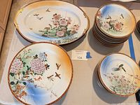 Group view of platters, plates and stacked bowls displaying pattern and quantity
