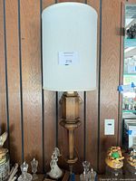 Front view of assembled sconce on wall with shade