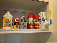Shelf view of all nine cleaning and lubricant containers